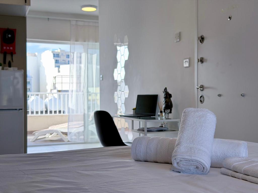 a room with a bed with towels on it at D' Suites Holiday Apartments in Il-Gżira