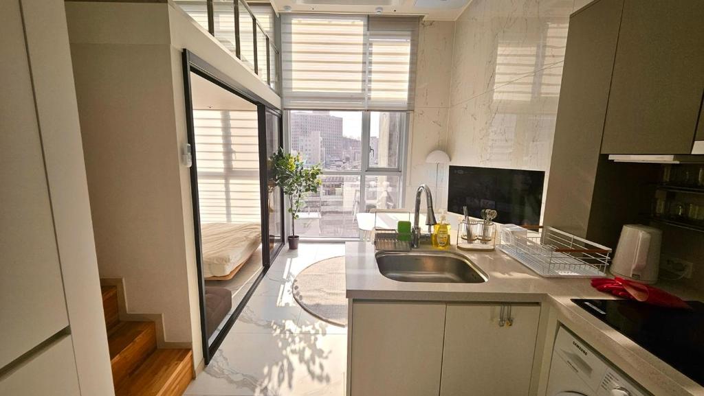 a kitchen with a sink and a computer on a counter at Arbo Unit in Seoul