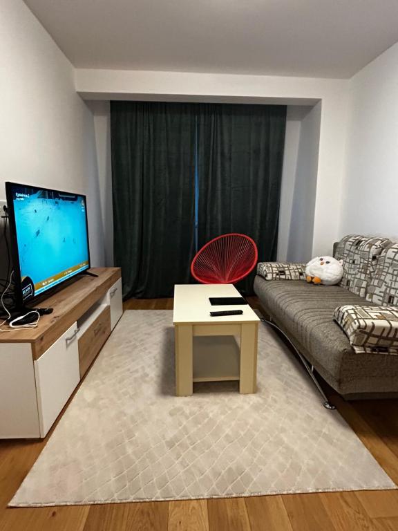 a living room with a couch and a table at Bjelašnica by Samke in Bjelašnica