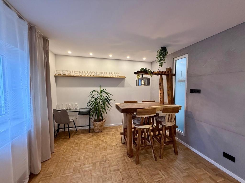 a dining room with a table and a desk at Ferienwohnung Luna in Eppelborn