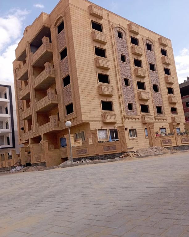 a tall building with balconies on the side of it at Canarya compound in 6th Of October
