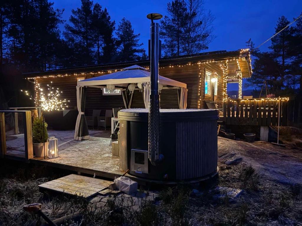 a hot tub in front of a house at night at Tonstad hytta in Tonstad