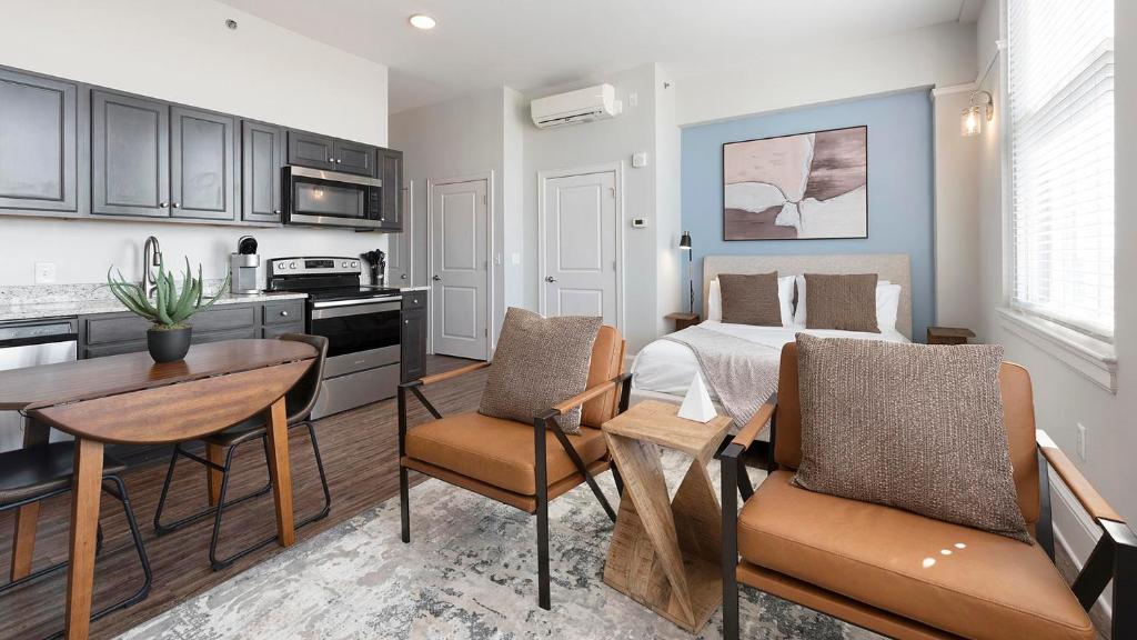 a kitchen and a living room with a bed and a table at Landing Amazing Studio Gym in Spartanburg