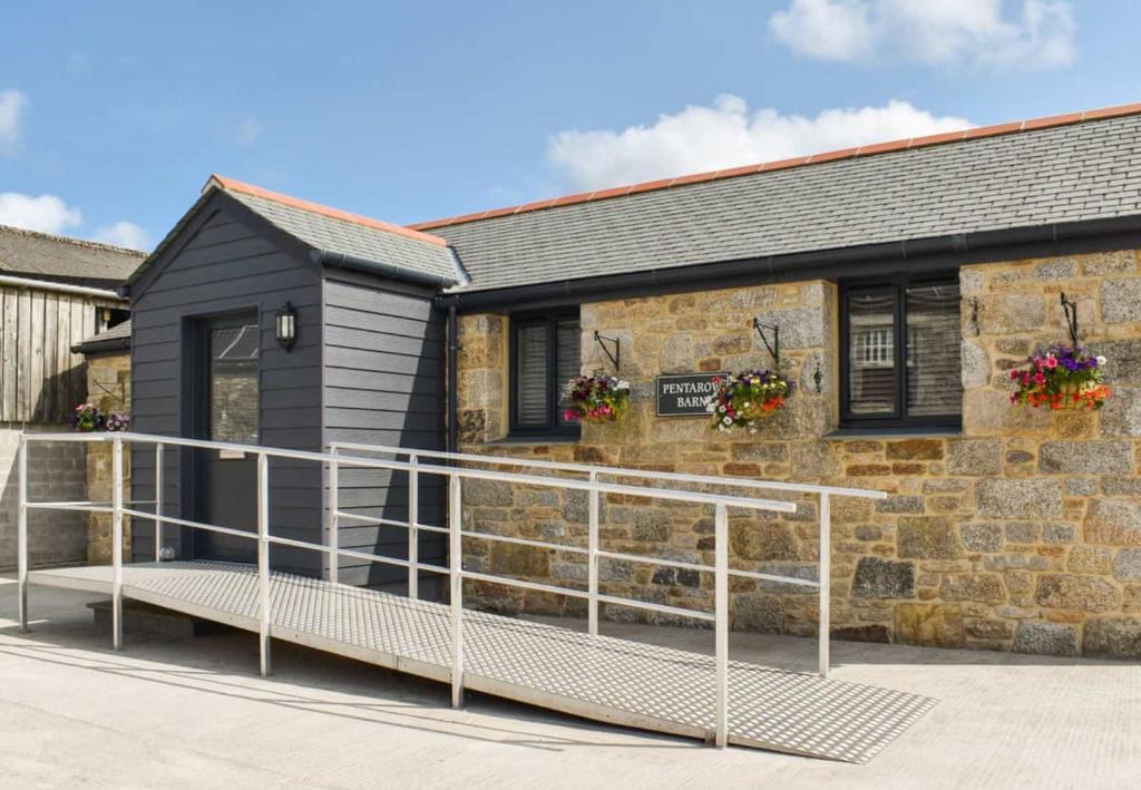 a building with a balcony in front of it at Pentarow Barn in Falmouth