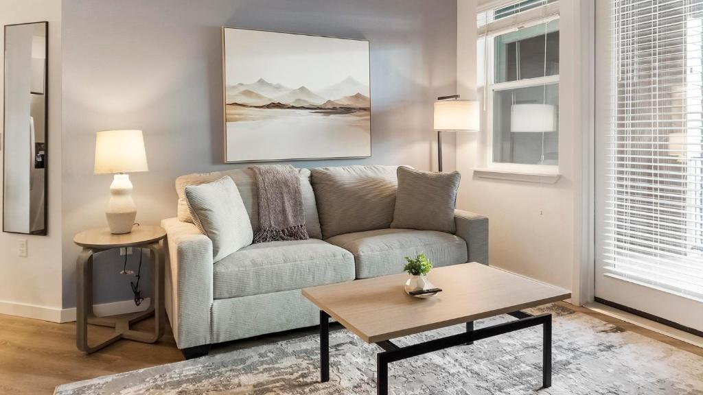 a living room with a couch and a table at Landing Stylish 2BD Gym Pool in Colorado Springs