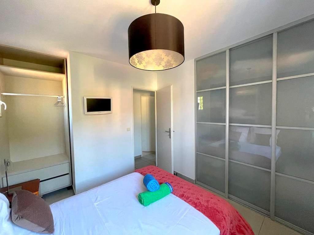 a bedroom with a large white bed with a toy on it at Vila paradise in Ollioules