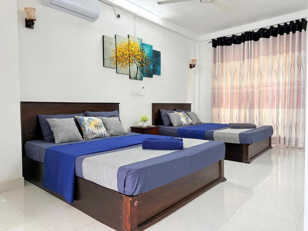 a bedroom with two beds and a couch at NO 10 Kandy by Kepler & Earth in Kandy