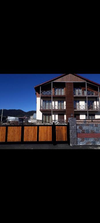 a building with a fence in front of it at Villa Bakuriani hotel in Bakuriani
