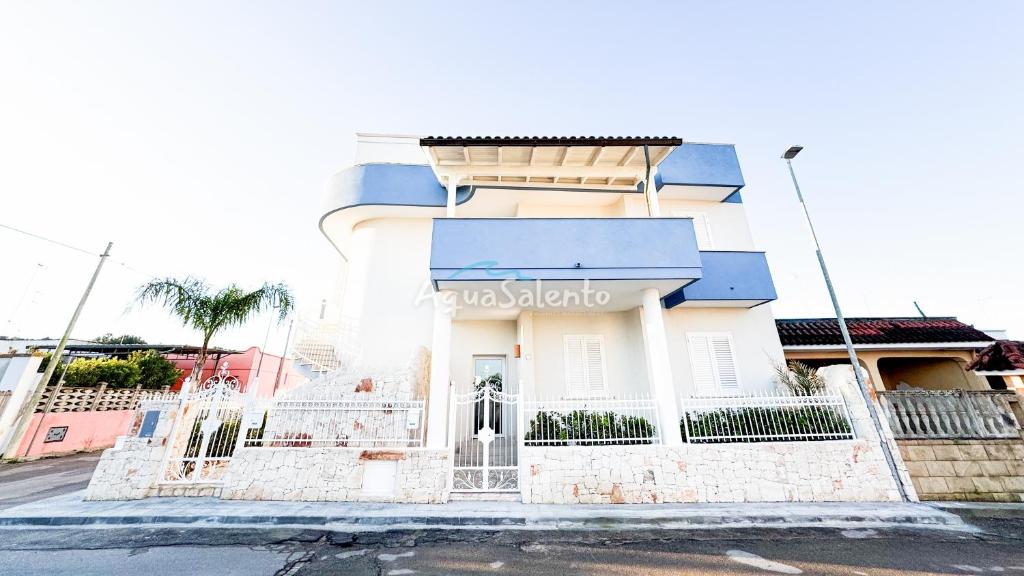 a white building with a sign on the side of it at AQUARAMA Rooms & Apartments in Torre Squillace