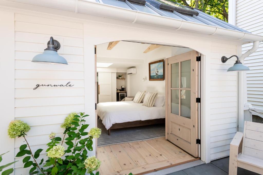 a white shed with a door leading into a bedroom at sisu, a boutique motel in Plymouth