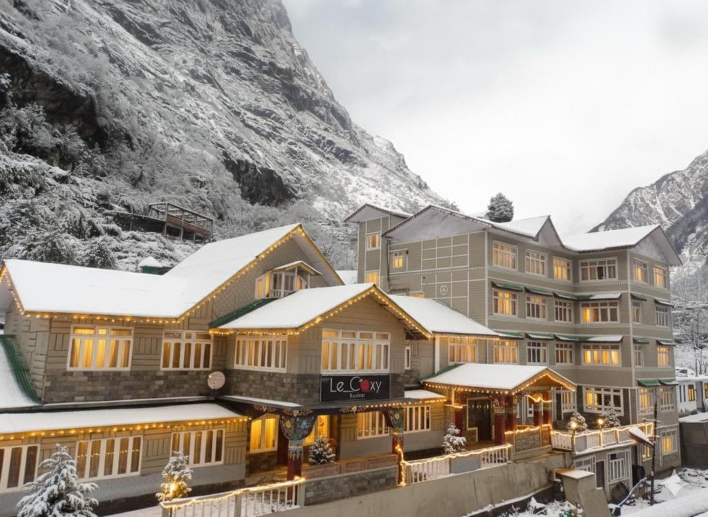 a hotel in the mountains with snow at Lecoxy Resort in Lachung