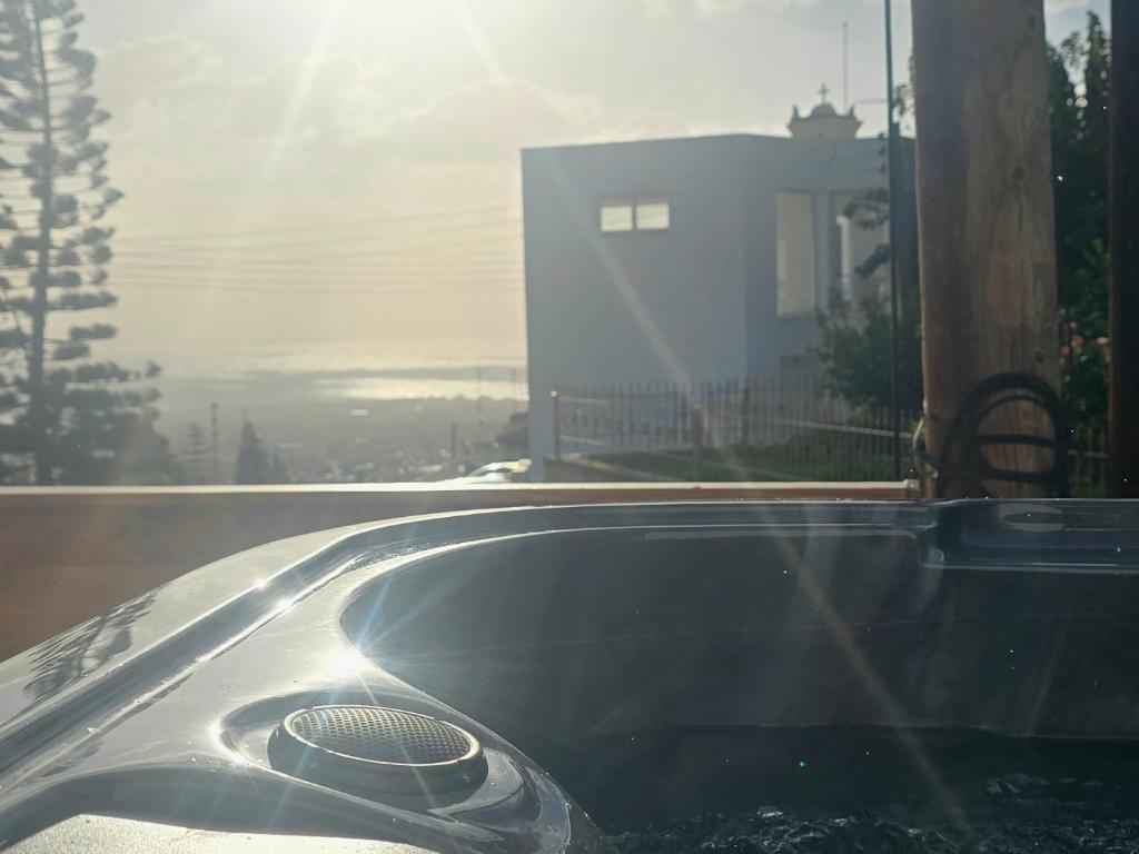 a bath tub sitting in front of a window at Blue Horizon Studio in Peyia