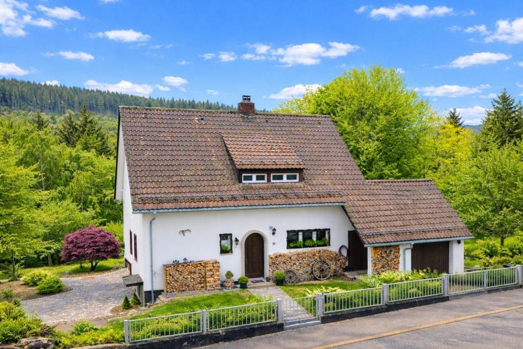 a white house with a brown roof at Ferienhaus Feldberg im Schwarzwald in Mittelfalkau