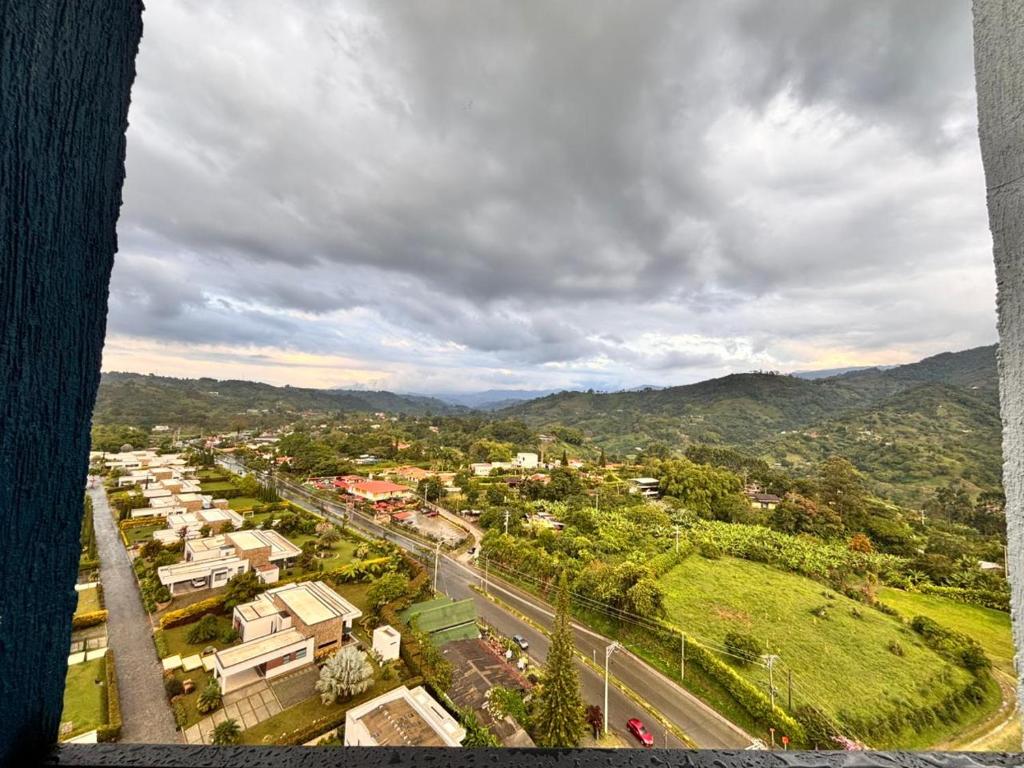 an aerial view of a city with houses and a road at Posada del Quindío 0219 in Armenia