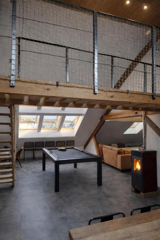 a ping pong table in the middle of a room at L'industriel - meublé de tourisme 4 étoiles in Fécamp