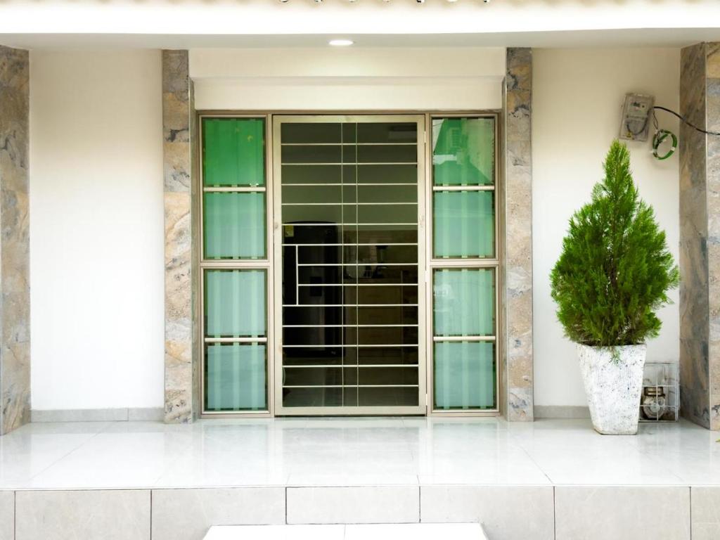 a window on a building with a potted plant at Coral del mar in Tolú
