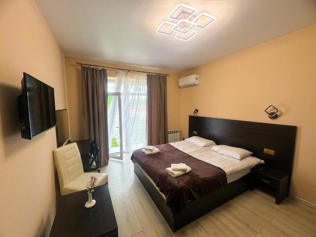 a bedroom with a large bed and a window at Glory Apart Polyana in Polyana
