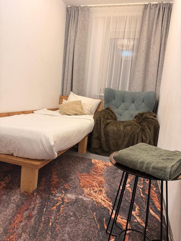 a bedroom with a bed and a couch and a chair at Sloth Room in Warsaw