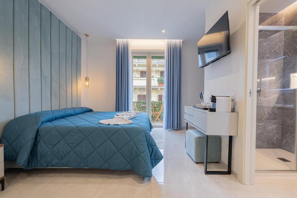 a bedroom with a blue bed and a window at Affittacamere Sulle Stelle in La Spezia