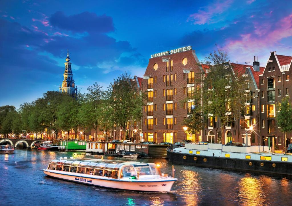 a city street filled with lots of tall buildings at Luxury Suites Amsterdam - Member of Warwick Hotels in Amsterdam
