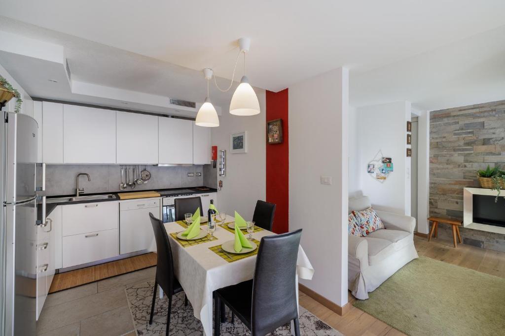 a kitchen and dining room with a table and chairs at Brentsch A27 in Scuol
