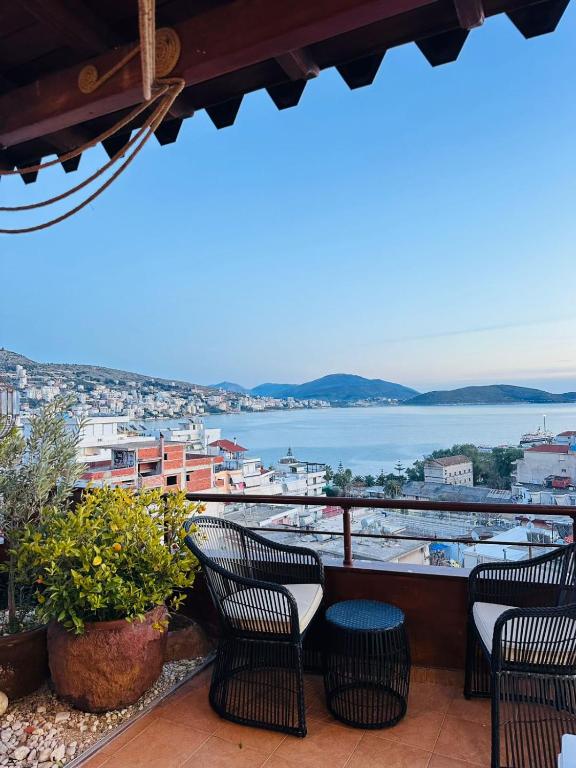 a balcony with chairs and a view of the water at Eye Luxury Penthouse & apartment in Sarandë