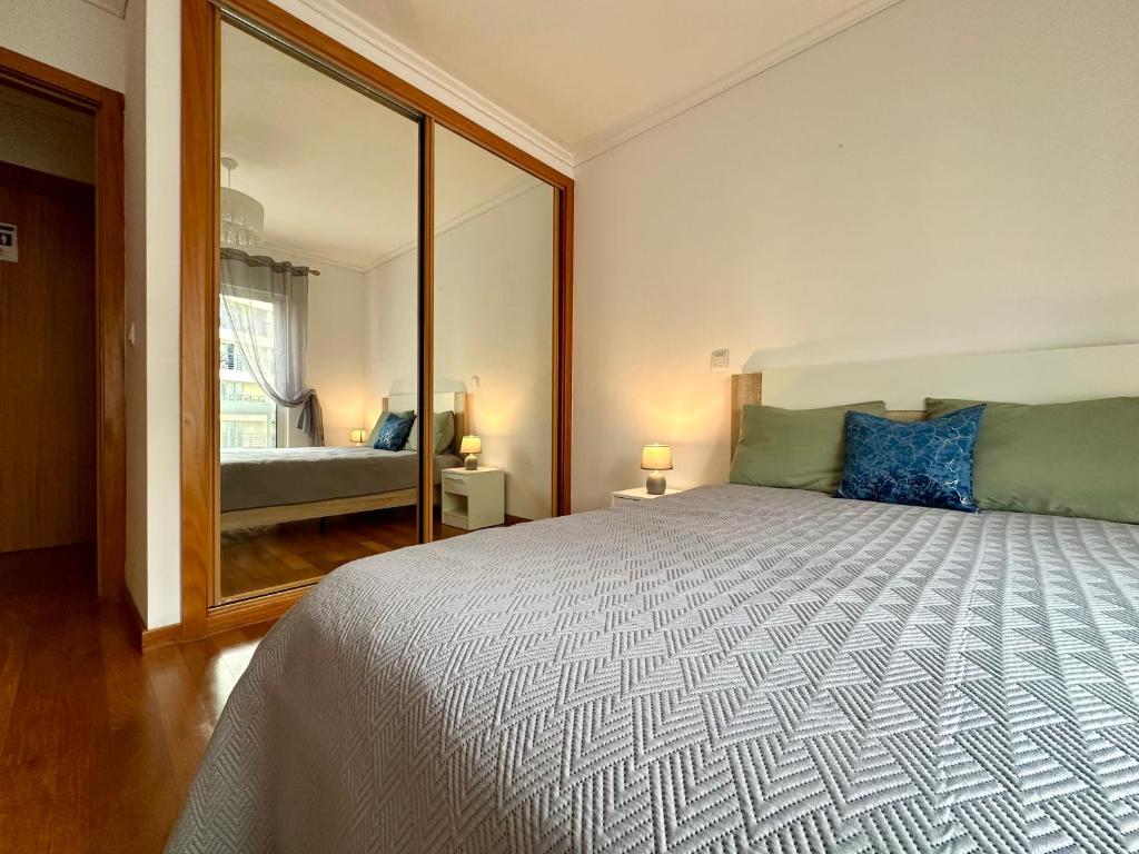 a bedroom with a large bed with a large mirror at Sea Soul residencial in Funchal