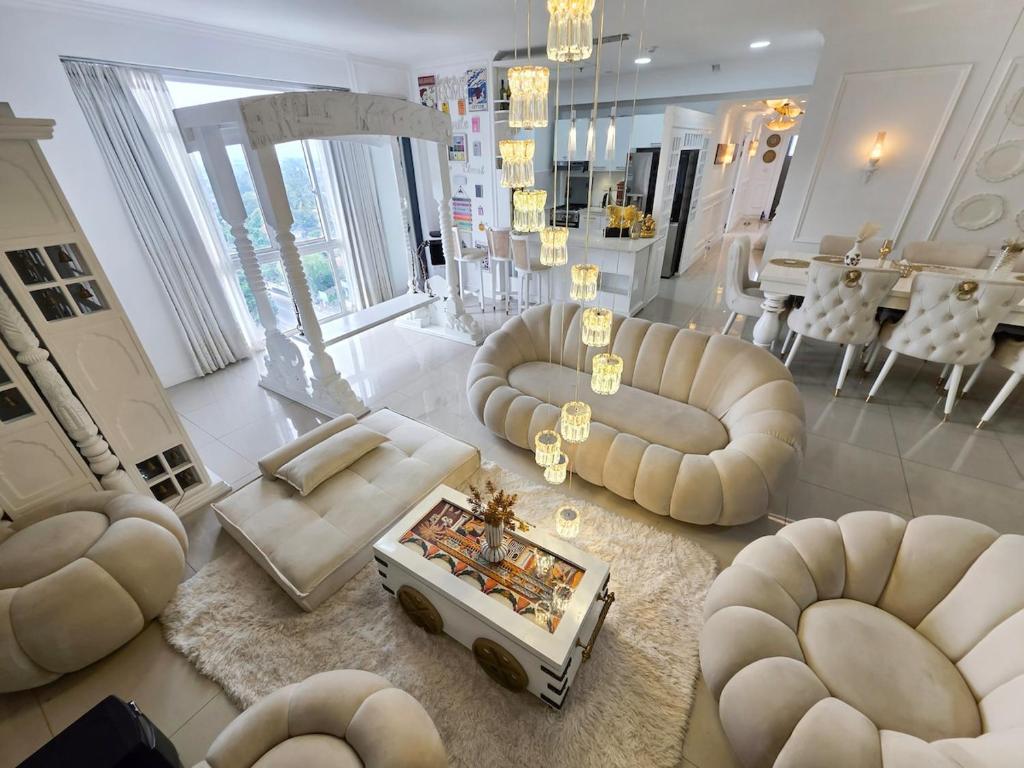 a living room with couches and a table at Evolve Madhura in Peliyagoda