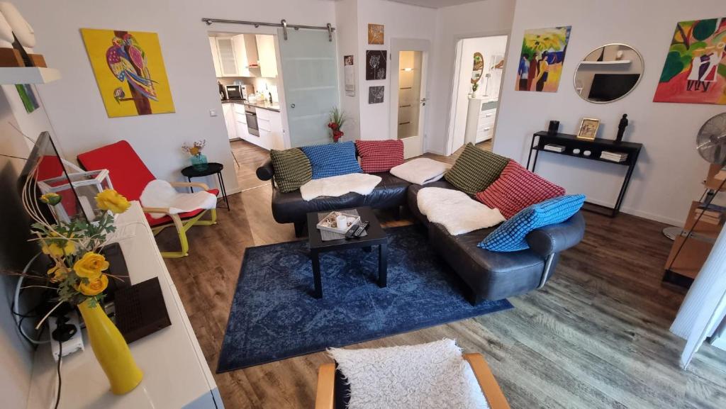 a living room with two couches and a blue rug at Moderne Wohnung Cathy in Bad Iburg