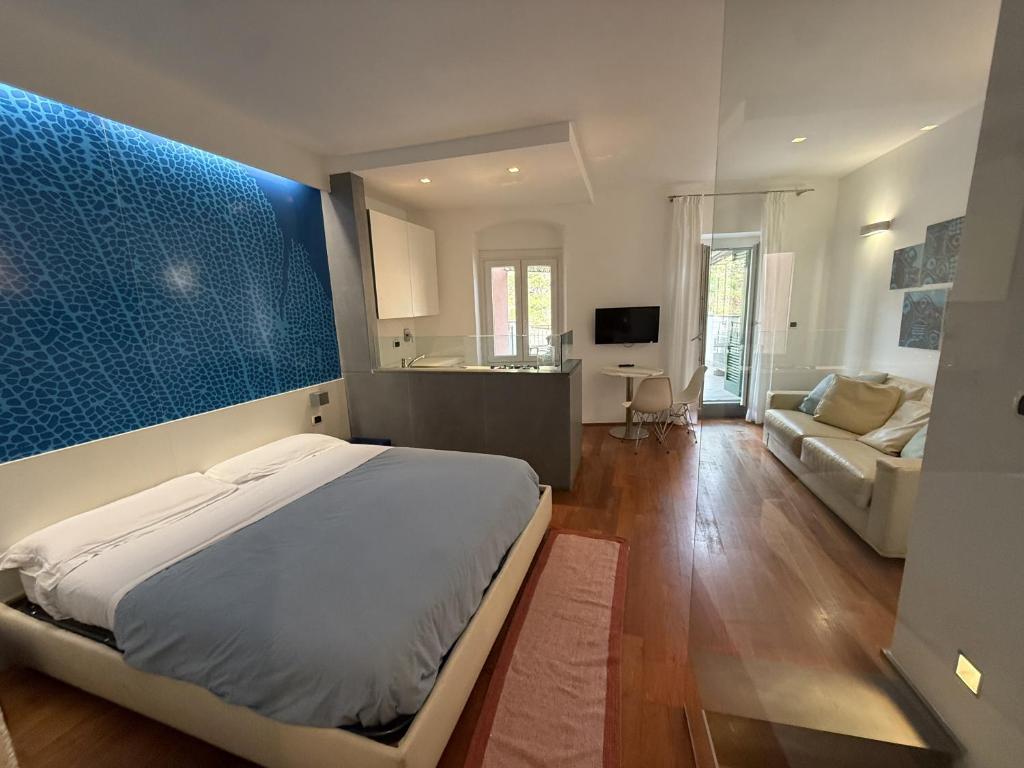 a bedroom with a bed and a living room at Mare Mosso 1 in Manarola