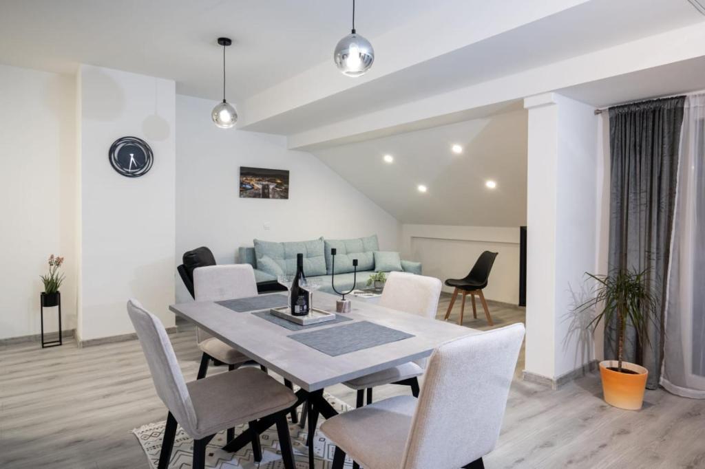a dining room and living room with a table and chairs at Fort Vista in Knin