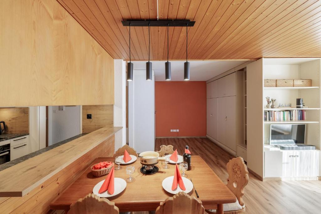 a kitchen and dining room with a table and chairs at Brentsch A30 in Scuol