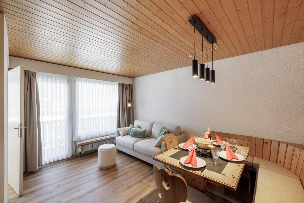 a living room with a couch and a table at Brentsch A29 in Scuol