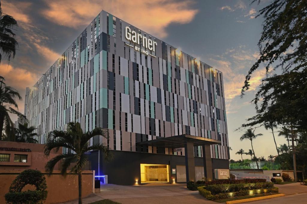 a building with a sign on the side of it at Garner Hotel Mazatlan Beach by IHG in Mazatlán
