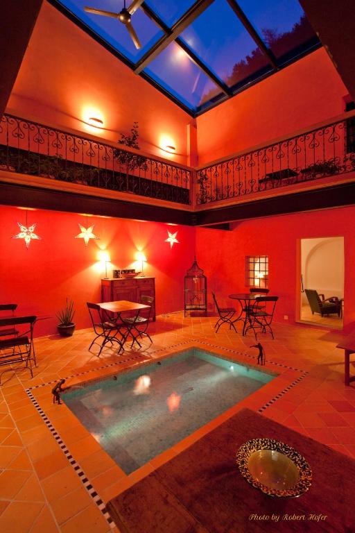 a large room with a swimming pool in a building at Le Jardin de Kabir in Martigny-Ville