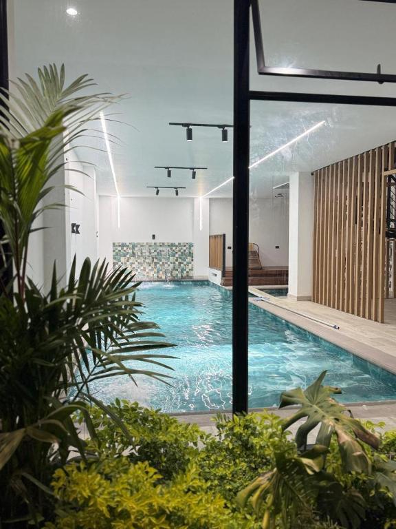 a large swimming pool in a building with plants at View Theras Hotel in Doradal