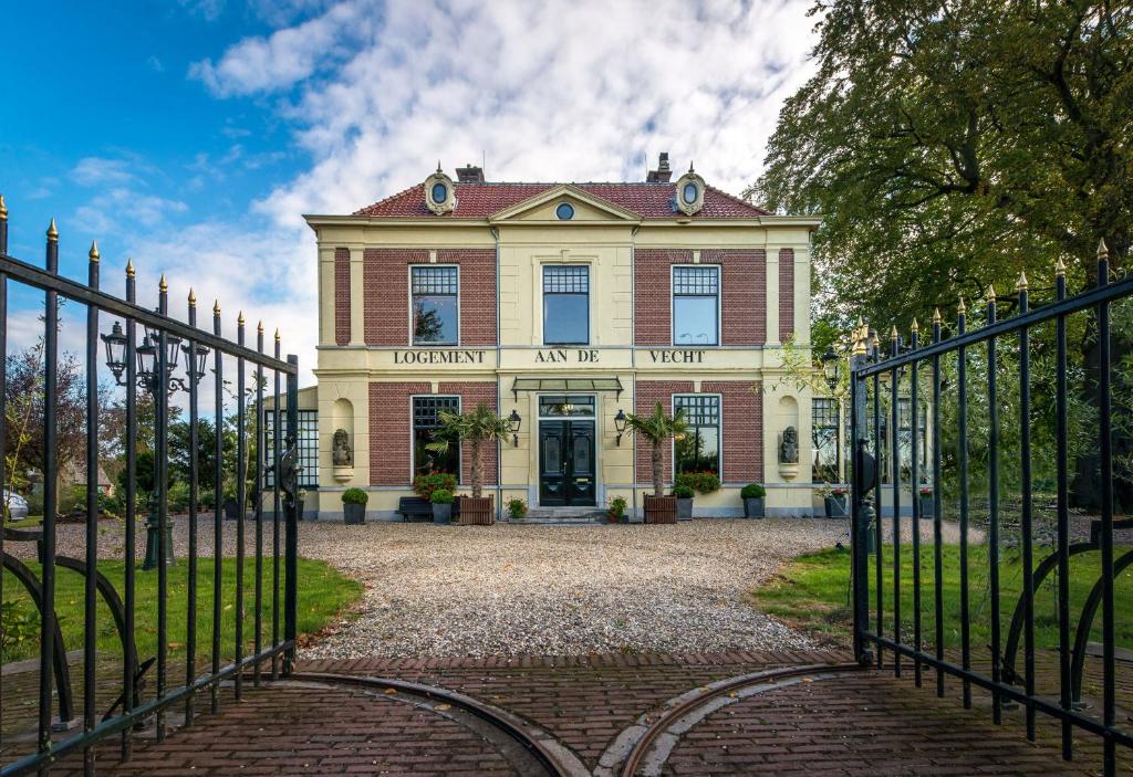 una entrada a una casa grande con una puerta en Logement aan de Vecht en Breukelen
