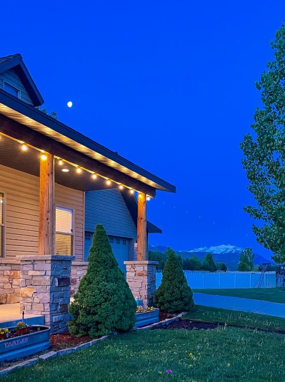 a house with lights on the front of it at Mountain View Adventures in Heber City