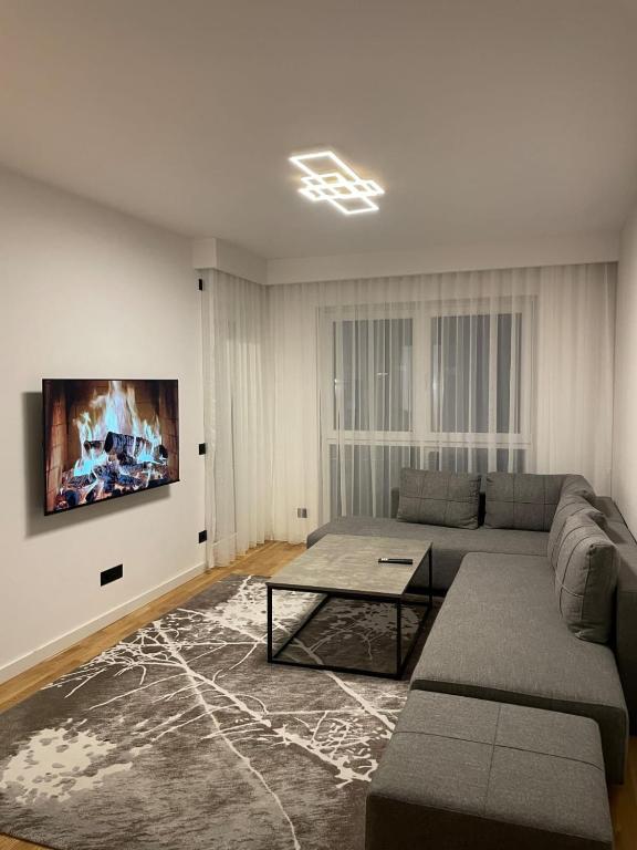a living room with a couch and a table at ZONE apartments in Prishtinë