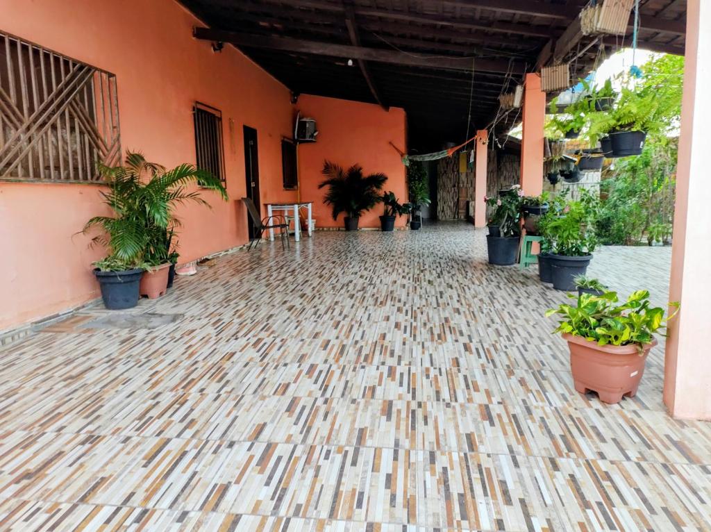 an empty courtyard with potted plants in a building at Rosa cheirosa in Barreirinhas