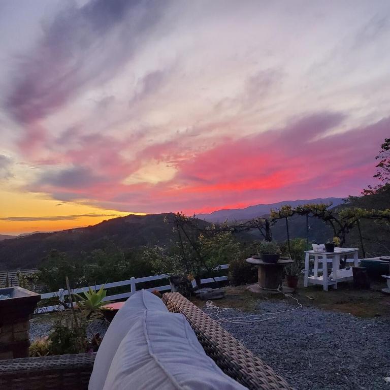 a sunset from the deck of a house with at Beverlys Hilltop Retreat in Fallbrook