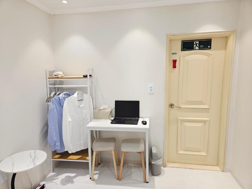 a room with a desk with a laptop computer on it at Han River KS Stay in Seoul