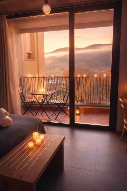 a room with a bed and a window with a view at Hostal Boutique Restaurante El Algars in Caseras