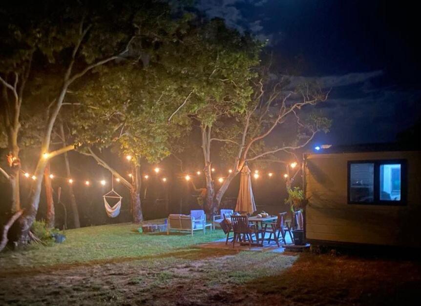 a backyard at night with a tent and lights at Cabin on the Creek in Boyne Island