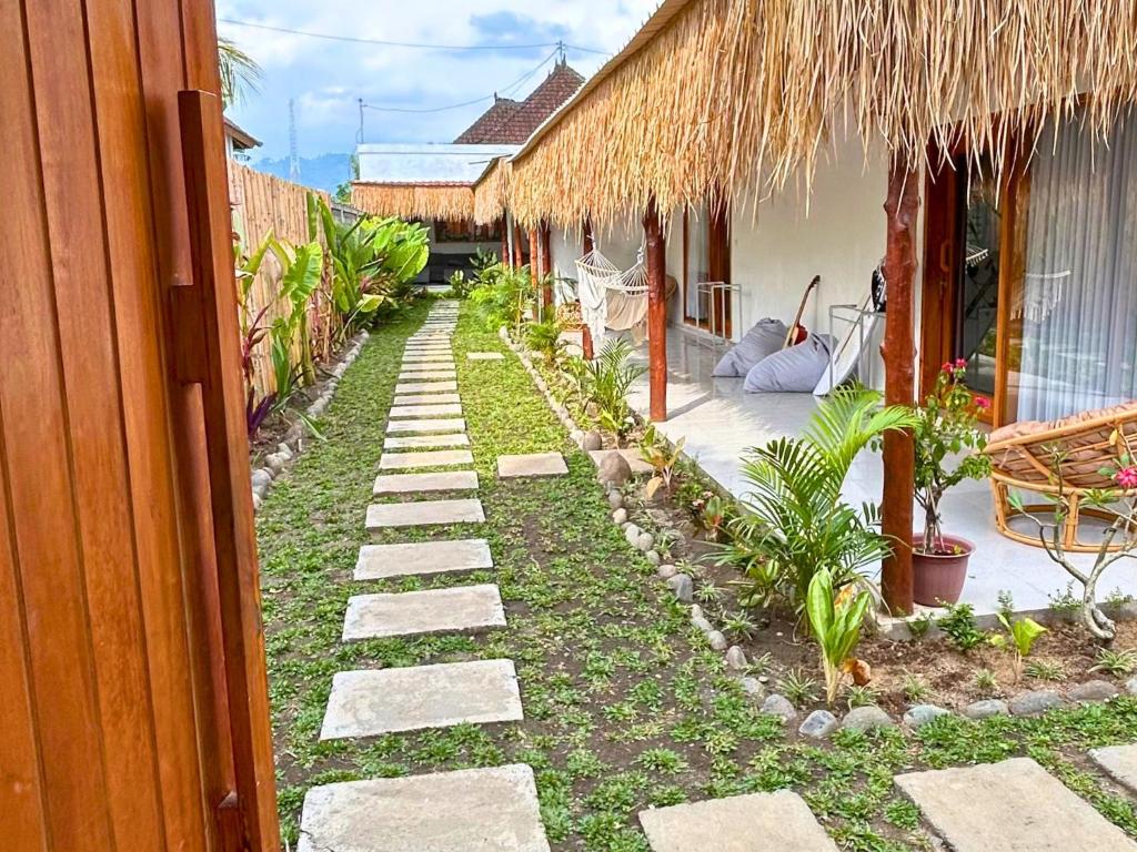a walkway leading to a house with a yard at The middle Surf house in Airsatang