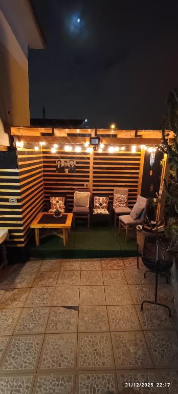 a patio with a table and chairs and lights at casona amplia y comoda in La Serena