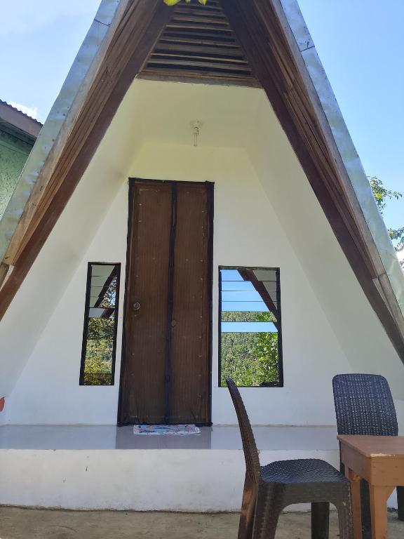 a room with a door and a table and a chair at Manga's swimming pool in El Nido Airport