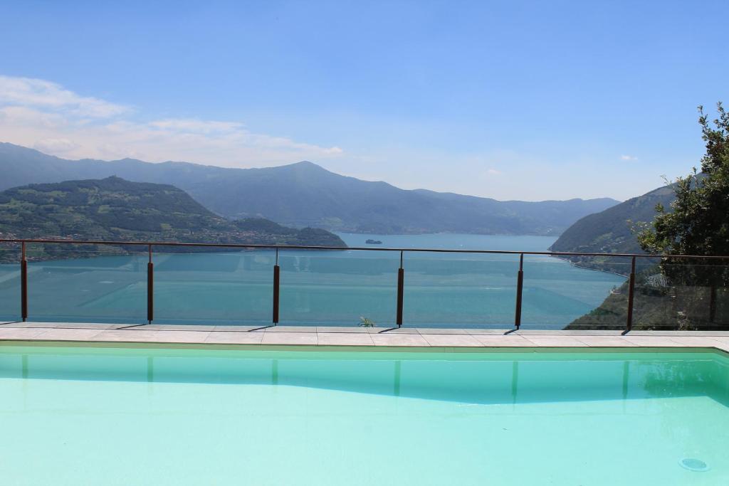 a swimming pool with a view of the water at Vista Paradiso in Parzanica