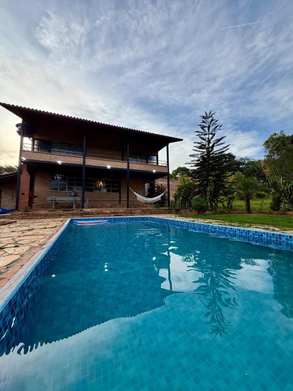 a large swimming pool in front of a house at Recanto do Amaral - Espaço de Lazer e Eventos in Betim
