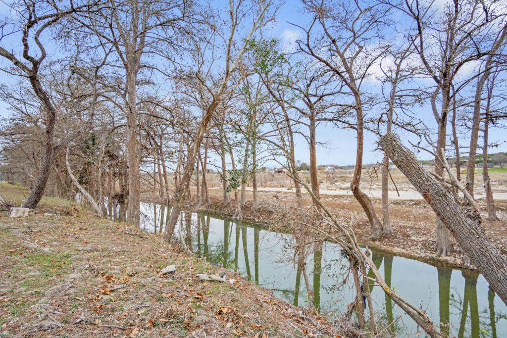 a body of water next to a group of trees at Guadalupe Getaway in Kerrville